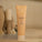 Super Smooth resurfacing body lotion is placed upon a counter. The bottle is light peach with a floral design on the tube and screw lid.
The product contains plant AHAs, pomegranate enzymes and noni fruit extract.